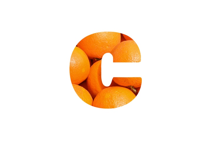 c vitamin and orange on white background