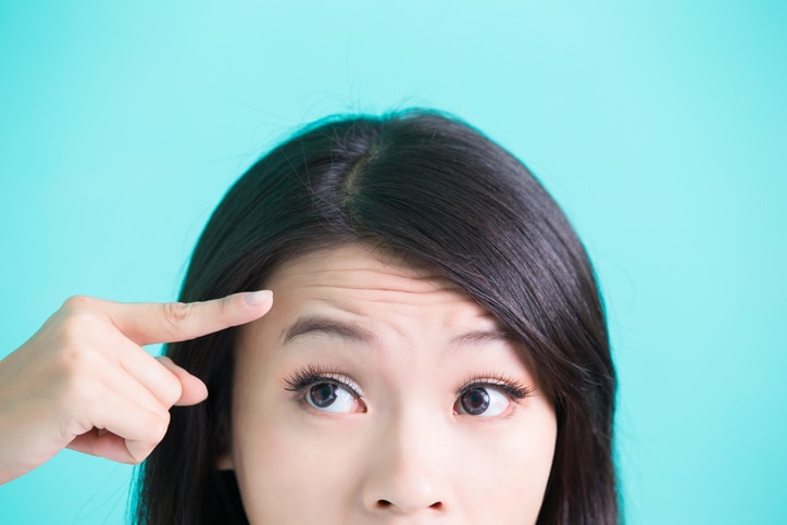 beauty skincare woman with wrinkle problem on green background