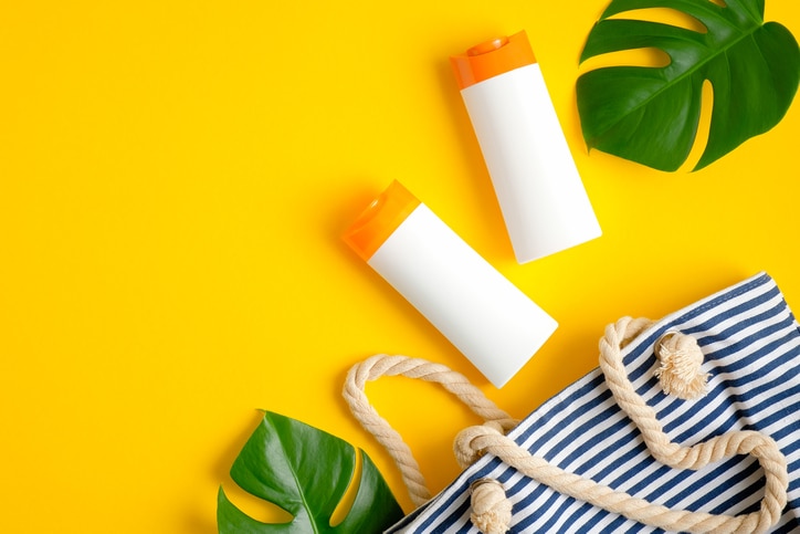 Taking sunscreen lotion from the shelves of the pharmacy store, close-up view