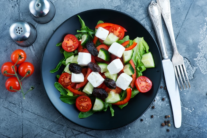 greek salad on plate and on a table