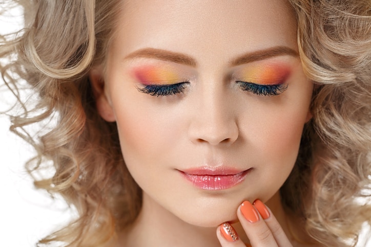 Colorful make up shadows and nails woman beauty portrait isolated on white. Studio shot.