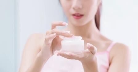 beauty woman with moisturizer concept in the bathroom