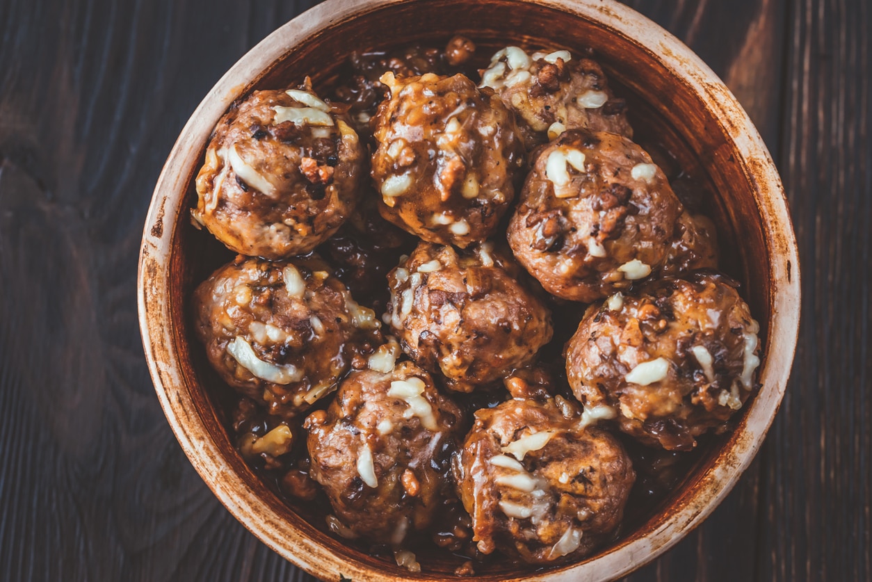 Bowl of beef and pork meatballs with grated cheese