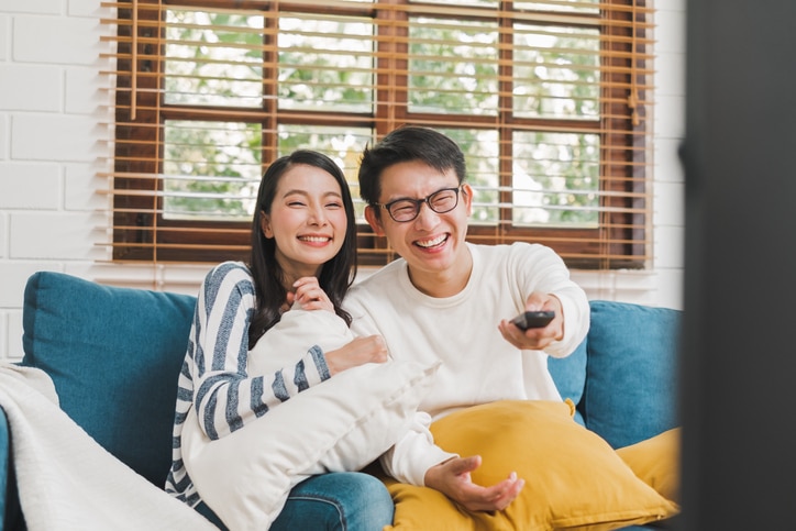 Asian couple lifestyle, man and woman watching TV movies at home, family lifestyle relax and recreation concept