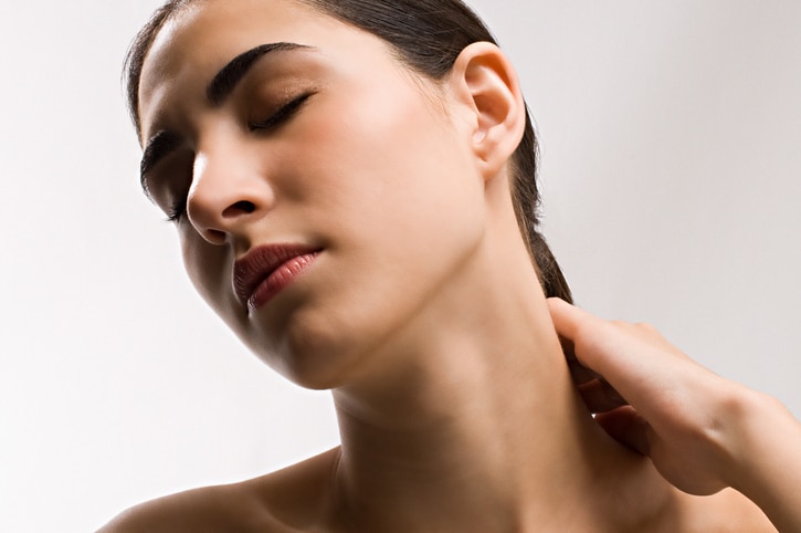 Woman rubbing neck