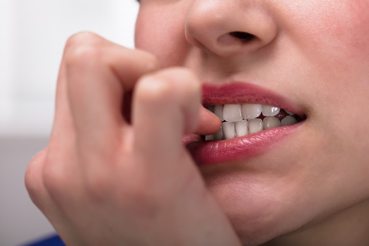 Close-up Of A Businesswoman Biting Her Fingernail