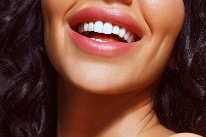 Beautiful toothy smile.    Close up, portrait of a happy, toothy smile, smiling young woman.