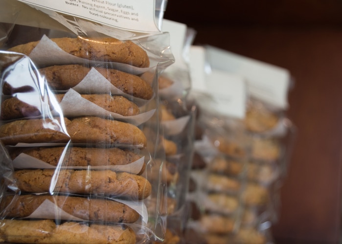 Close up of homemade biscuits packaged in cellophane packets on a shelf