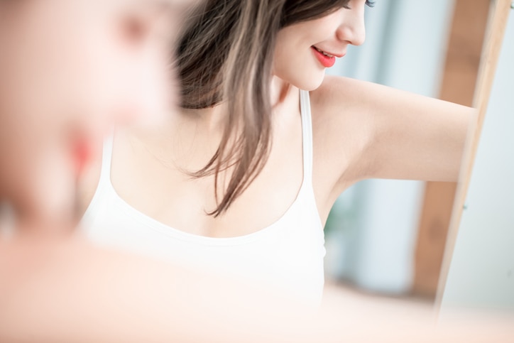 beauty woman smile with clean underarm in front of mirror