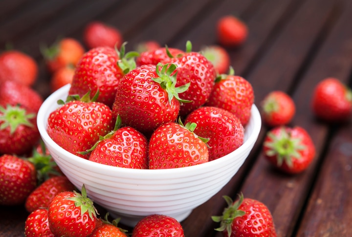 Fresh strawberries on wooden background. Copy space