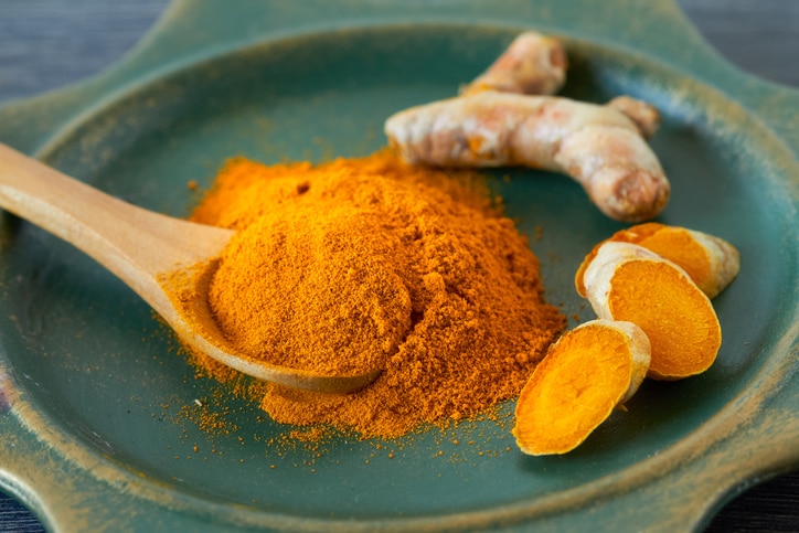 Turmeric root and turmeric powder , close up