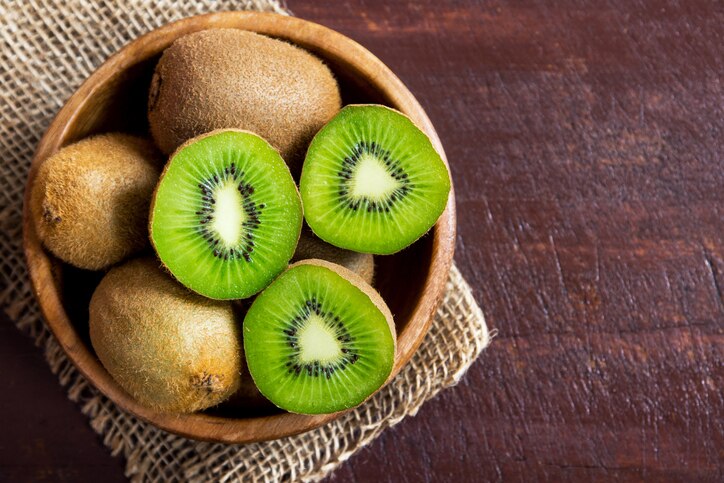 Kiwi fruit on wooden background with copy space