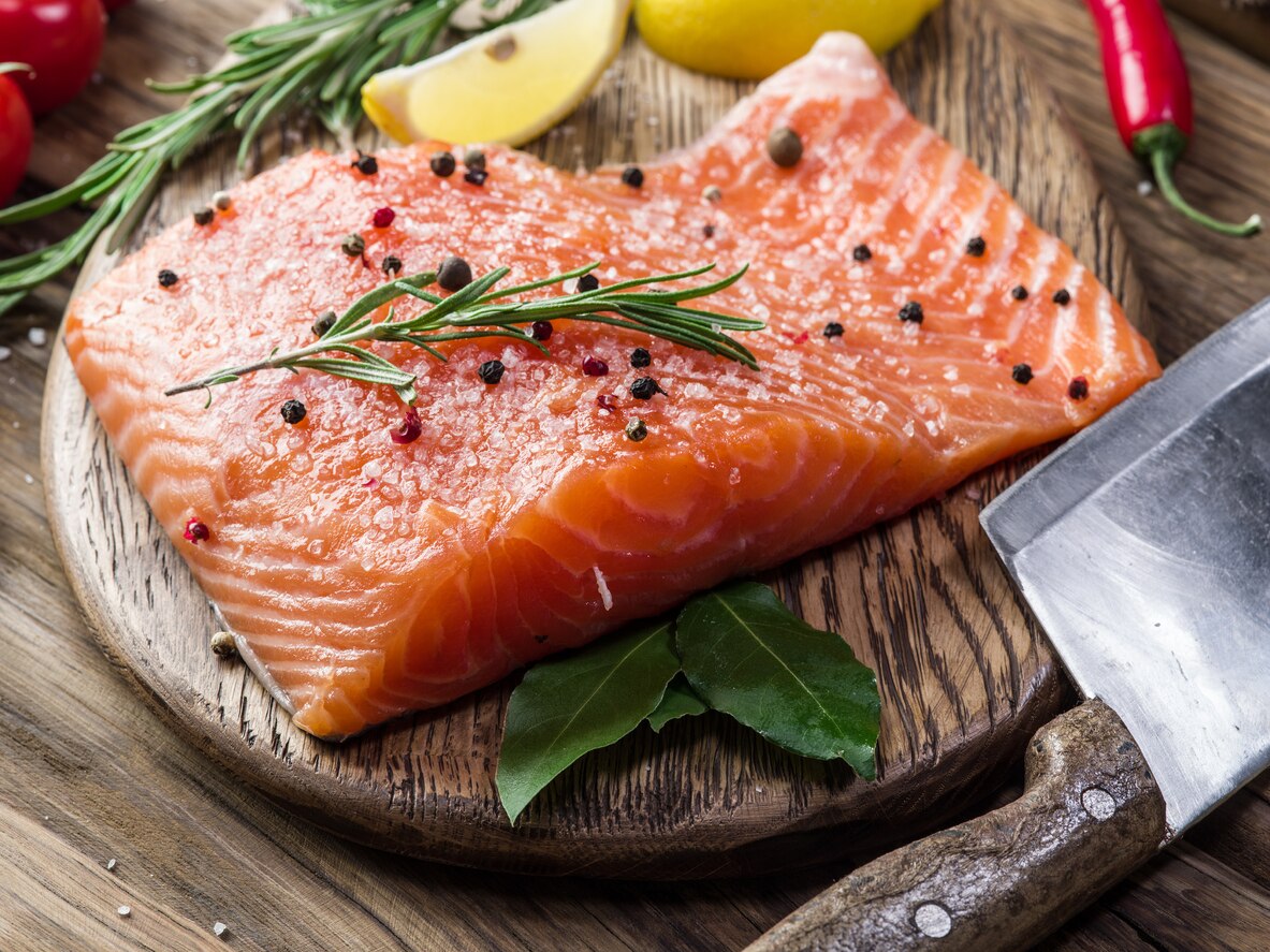 Fresh salmon on the cutting board. Cooking process.