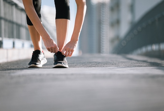 Young woman in the city getting ready for a run.