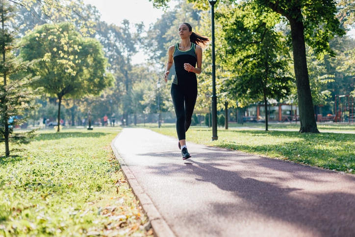 Woman running on jogging path in the park