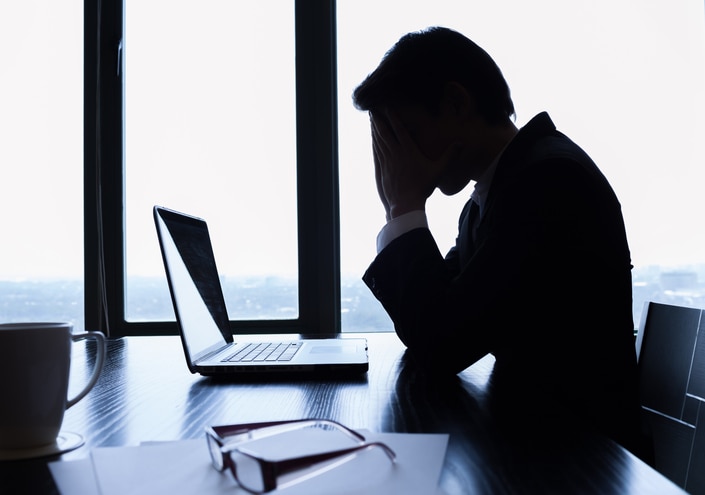 Silhouette of stressed business man in the office.