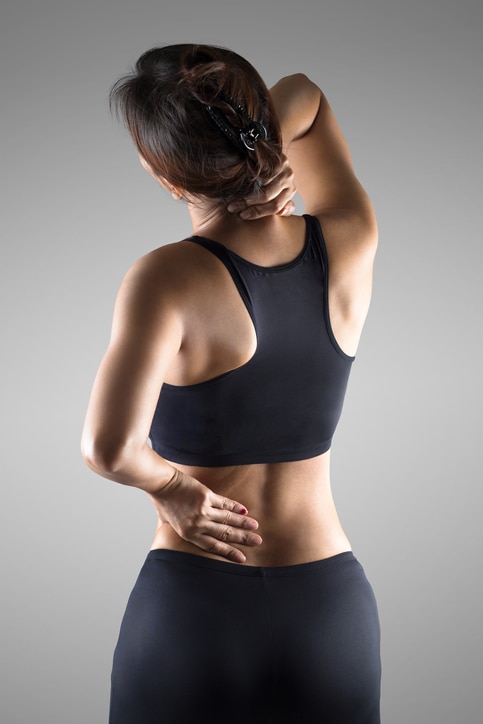 Female with pain back pain and neck pain, Isolated over grey background