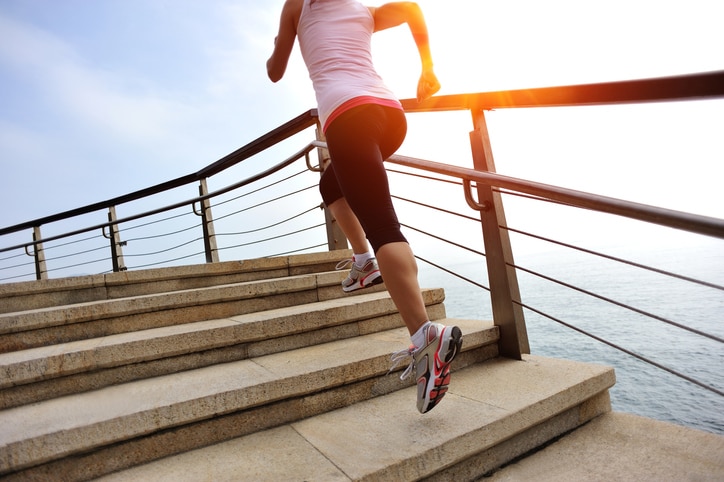 healthy lifestyle asian woman running at stone stairs seaside