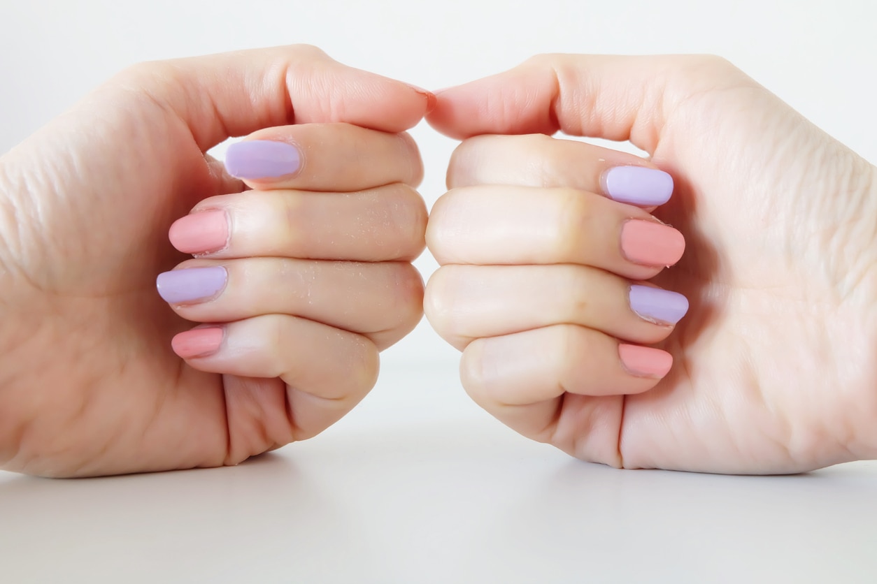 Close Up Nail Polish Manicure. Beautiful Woman is Hands on Pink and Violet Pastel on White Background Great for Any Use.