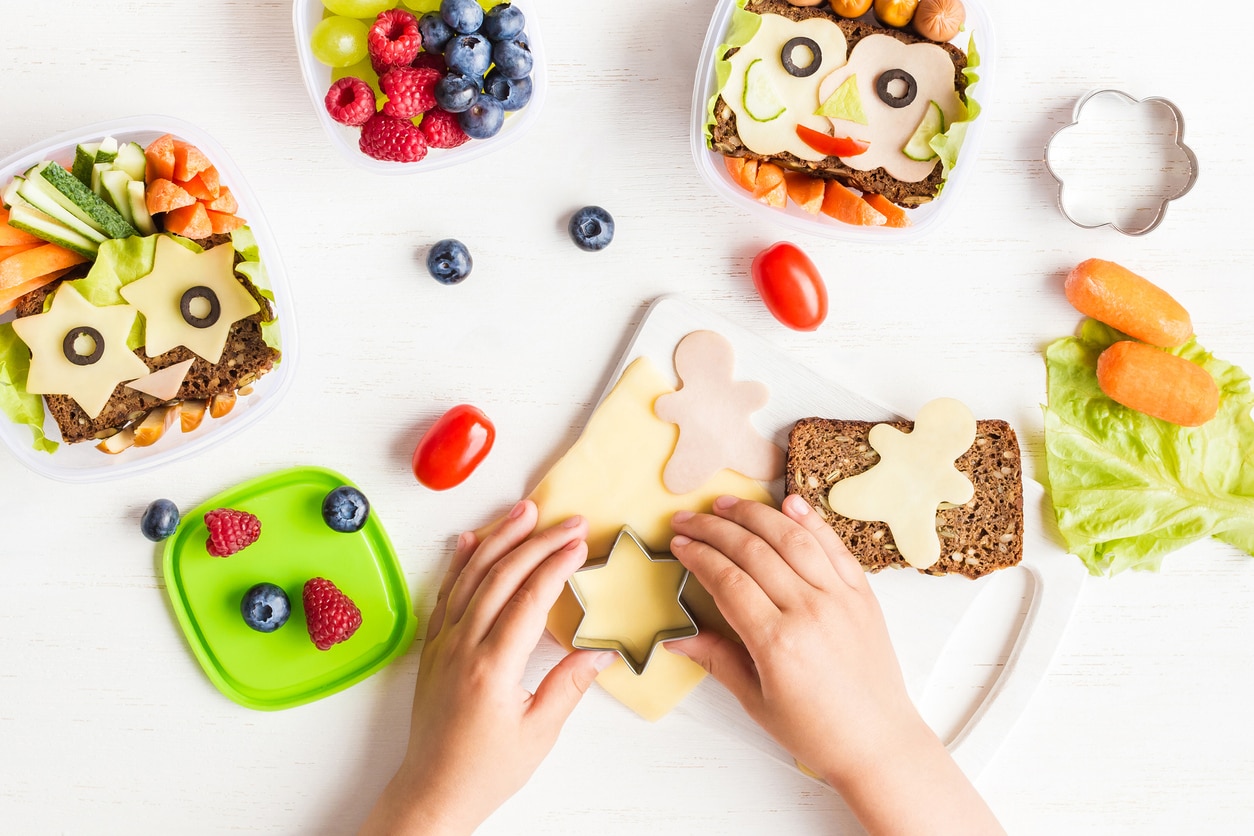 Make veggie tasty and colourful helps to encourage kids to eat vegetables, School lunch box for kids. Cooking. Child's hands. Top view, flat lay