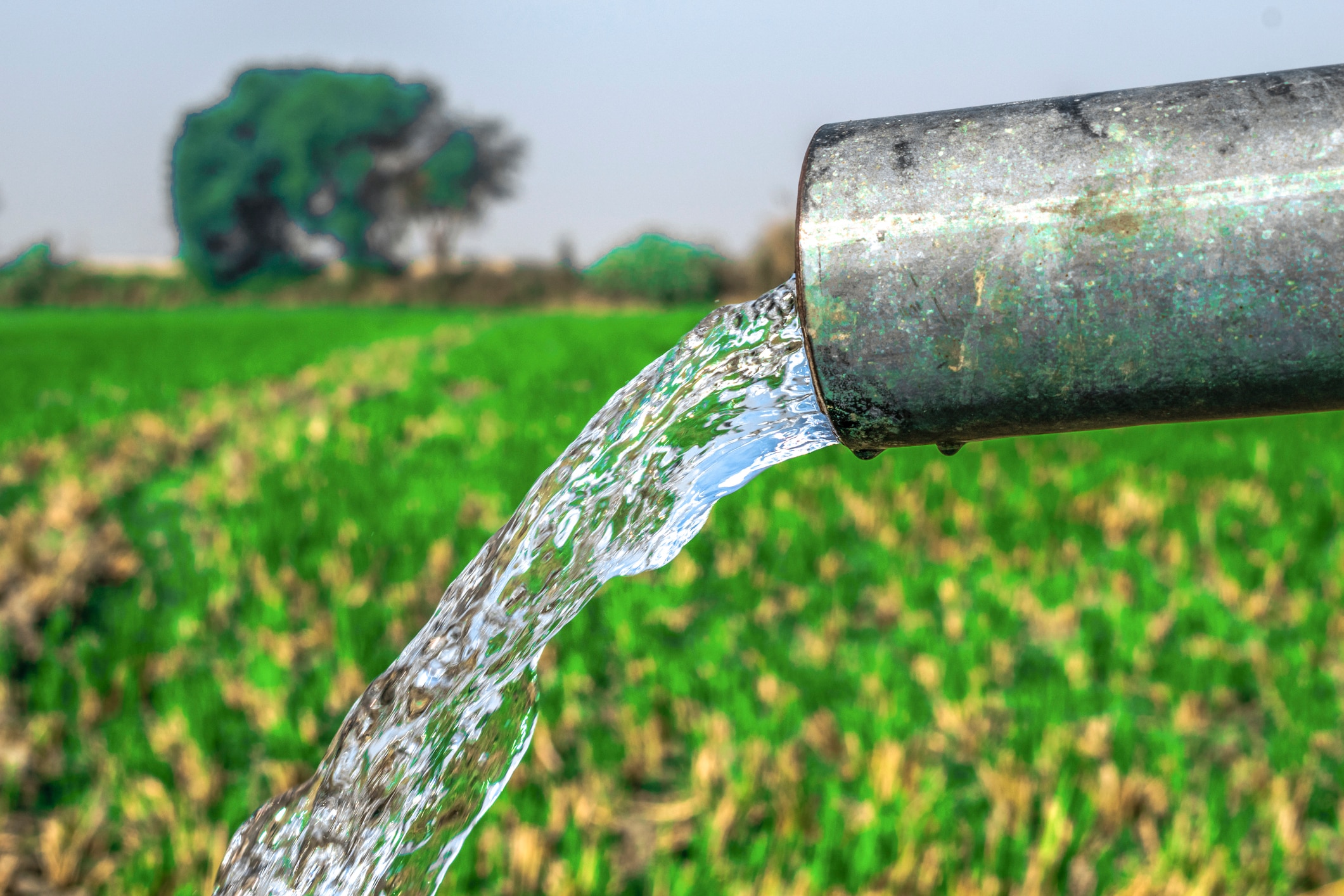 high pressure crystal bluish sweet water flushing out of an agriculture industrial tube well in fields